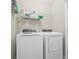 Well-equipped laundry room featuring a modern washer and dryer with overhead storage at 2771 Suncoast Blend Dr, Odessa, FL 33556