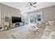 Bright living room with a comfortable sectional sofa, plush rug, and sliding glass doors to the outdoors at 2771 Suncoast Blend Dr, Odessa, FL 33556