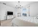 Serene bedroom with soft carpet, a modern chandelier, and a view to the outdoors at 2771 Suncoast Blend Dr, Odessa, FL 33556