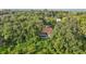 Secluded property showcases a well-maintained pool and a screen enclosure amid lush greenery at 2990 Longbrooke Way, Clearwater, FL 33760