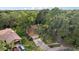 Aerial perspective of a home with beautiful, mature trees in a serene, residential neighborhood at 2990 Longbrooke Way, Clearwater, FL 33760