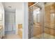 Modern bathroom featuring a glass-enclosed shower, bathtub, and ample storage space at 2990 Longbrooke Way, Clearwater, FL 33760