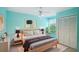 Brightly painted bedroom featuring modern decor, including a ceiling fan, stylish lamps, and a comfortable bed at 2990 Longbrooke Way, Clearwater, FL 33760