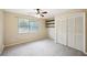 A spacious bedroom with neutral walls, large windows, and a closet, offering a blank canvas for personalization at 2990 Longbrooke Way, Clearwater, FL 33760