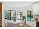Bright dining area with hardwood floors, views of outdoor pool, and elegant furniture at 2990 Longbrooke Way, Clearwater, FL 33760