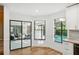 Bright dining area with hardwood floors, views of outdoor pool, and elegant furniture at 2990 Longbrooke Way, Clearwater, FL 33760
