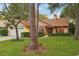 Welcoming home featuring lush landscaping, a side entry garage and a manicured lawn at 2990 Longbrooke Way, Clearwater, FL 33760