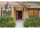 Charming front exterior with neat landscaping, warm lighting, and a welcoming entrance way at 2990 Longbrooke Way, Clearwater, FL 33760