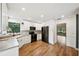 Modern kitchen featuring white cabinets, stainless steel appliances, and wood flooring at 2990 Longbrooke Way, Clearwater, FL 33760