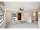 Spacious living room featuring a view of the pool, sliding glass door, and plenty of natural light at 2990 Longbrooke Way, Clearwater, FL 33760