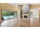 Bright living room with vaulted ceilings, wood floors, fireplace, and sliding glass doors to the pool at 2990 Longbrooke Way, Clearwater, FL 33760