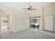 Spacious main bedroom with neutral carpet, ceiling fan, and lanai access at 2990 Longbrooke Way, Clearwater, FL 33760