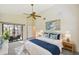 Bright main bedroom with ceiling fan, ensuite, and sliding doors to lanai at 2990 Longbrooke Way, Clearwater, FL 33760
