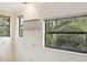 Bright room featuring large windows with scenic views and floating shelves for storage or display at 2990 Longbrooke Way, Clearwater, FL 33760