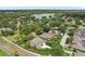 Scenic aerial view of luxury homes surrounded by lush landscaping and a sparkling lake, perfect for serene living at 3062 Sutton Woods Dr, Plant City, FL 33566
