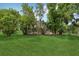 Lush backyard with mature trees and pool area at 3062 Sutton Woods Dr, Plant City, FL 33566