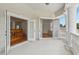 Open-air balcony with columns, french doors, and a view of the home's interior at 3062 Sutton Woods Dr, Plant City, FL 33566
