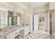 Well-lit primary bathroom with marble countertops, dual sinks, and a walk-in shower at 3062 Sutton Woods Dr, Plant City, FL 33566