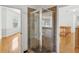 Glass shower with tile surround and hardwood floors at 3062 Sutton Woods Dr, Plant City, FL 33566