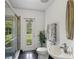 Contemporary bathroom featuring a shower, sink, and garden view at 3062 Sutton Woods Dr, Plant City, FL 33566