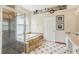 Bright bathroom featuring a shower, garden tub, and marble countertop at 3062 Sutton Woods Dr, Plant City, FL 33566
