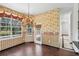 Cozy breakfast nook with pool view, featuring chandelier, elegant wallpaper, and a door to the outside at 3062 Sutton Woods Dr, Plant City, FL 33566