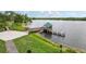 Picturesque pier with a covered gazebo extending into a tranquil lake, perfect for lakeside enjoyment at 3062 Sutton Woods Dr, Plant City, FL 33566