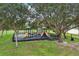 Fun community playground with slides and climbing structures, perfect for Gathering enjoyment surrounded by mature trees at 3062 Sutton Woods Dr, Plant City, FL 33566