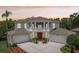 Elegant two-story home featuring a grand entrance with columns, balcony, and attached two-car garages at 3062 Sutton Woods Dr, Plant City, FL 33566