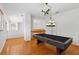 A rec room is shown with wood floors and a pool table below an airplane light fixture at 3062 Sutton Woods Dr, Plant City, FL 33566