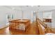 Elegant hallway featuring wood floors, stairs, and a stunning chandelier at 3062 Sutton Woods Dr, Plant City, FL 33566
