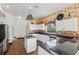 Bright, open kitchen featuring an island, granite countertops, and stainless steel appliances at 3062 Sutton Woods Dr, Plant City, FL 33566