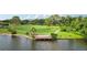 Inviting lakeside deck surrounded by lush greenery and scenic views, ideal for relaxing or entertaining at 3062 Sutton Woods Dr, Plant City, FL 33566
