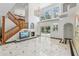 Bright living room featuring a fireplace, grand staircase, and large windows with backyard views at 3062 Sutton Woods Dr, Plant City, FL 33566