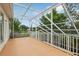 Screened patio with white frame and railing overlooking the yard at 3062 Sutton Woods Dr, Plant City, FL 33566