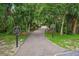 Scenic walking trail winding through lush greenery, perfect for a peaceful stroll in a pet-friendly environment at 3062 Sutton Woods Dr, Plant City, FL 33566