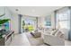 Bright living room featuring tile floors, neutral decor, and sliding glass doors to the backyard patio at 31463 Paper Birch St, Wesley Chapel, FL 33545