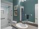 Well-lit bathroom featuring a tub and shower combination and a stylish vanity area at 3452 Forelock Rd, Tarpon Springs, FL 34688