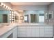 Spacious bathroom with dual sinks, vanity, and Hollywood-style lighting at 3452 Forelock Rd, Tarpon Springs, FL 34688