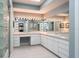 Bright bathroom featuring a large vanity with dual sinks and Hollywood-style lighting at 3452 Forelock Rd, Tarpon Springs, FL 34688
