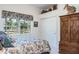 Bedroom featuring a window with garden views, and ample closet and dresser storage at 3452 Forelock Rd, Tarpon Springs, FL 34688