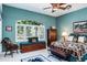 Cozy bedroom featuring Southwestern decor, a window seat, and a beautiful shuttered window at 3452 Forelock Rd, Tarpon Springs, FL 34688