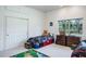 Bright bedroom with a car-themed bed, plush toys, and a window offering natural light at 3452 Forelock Rd, Tarpon Springs, FL 34688