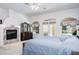 Bedroom featuring a fireplace, dresser, and lots of natural light at 3452 Forelock Rd, Tarpon Springs, FL 34688