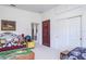 Cozy bedroom features a unique 'Fort Knox' door, plush toys, and carpeted flooring at 3452 Forelock Rd, Tarpon Springs, FL 34688