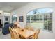 Bright breakfast nook with wood table set, and large windows with outdoor view at 3452 Forelock Rd, Tarpon Springs, FL 34688