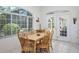 Bright breakfast nook with tile flooring, wood table set, and large windows with outdoor view at 3452 Forelock Rd, Tarpon Springs, FL 34688