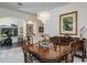 Dining room with a crystal chandelier, wooden table set, and neutral decor at 3452 Forelock Rd, Tarpon Springs, FL 34688