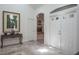 Inviting entryway featuring tile flooring, art display and skylight for natural light at 3452 Forelock Rd, Tarpon Springs, FL 34688