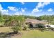 Lovely home with lush landscaping, mature palm trees, and manicured lawns, enhancing its curb appeal at 3452 Forelock Rd, Tarpon Springs, FL 34688